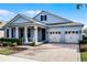 Two-story home with light blue siding, two-car garage, and a neatly landscaped front yard at 8547 Bayview Crossing Dr, Winter Garden, FL 34787