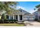 Beautiful two-story home with a light blue exterior, two-car garage, and well-manicured landscaping at 8547 Bayview Crossing Dr, Winter Garden, FL 34787