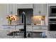 Close-up of a kitchen sink with a black gooseneck faucet and granite countertop at 8547 Bayview Crossing Dr, Winter Garden, FL 34787