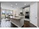 Modern kitchen with granite island, stainless steel appliances, and an adjacent dining area at 8547 Bayview Crossing Dr, Winter Garden, FL 34787