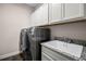 Modern laundry room with washer, dryer, and ample cabinetry at 8547 Bayview Crossing Dr, Winter Garden, FL 34787