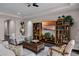 Living room with hardwood floors, built-in shelving and comfortable seating at 8547 Bayview Crossing Dr, Winter Garden, FL 34787