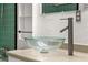 Modern bathroom features a glass vessel sink and updated faucet at 1012 N Ferncreek Ave, Orlando, FL 32803