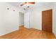 Simple bedroom with wood floors, ceiling fan and double door closet at 1012 N Ferncreek Ave, Orlando, FL 32803