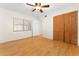 Simple bedroom with wood floors, ceiling fan, and built-in closet at 1012 N Ferncreek Ave, Orlando, FL 32803