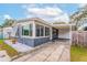 Gray and white ranch home with a carport and well-maintained landscaping at 1012 N Ferncreek Ave, Orlando, FL 32803