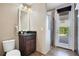 Bathroom with granite vanity, shower, and access to the backyard at 10389 Henbury St, Orlando, FL 32832