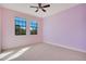 Spacious bedroom with two windows and light pink walls at 10389 Henbury St, Orlando, FL 32832