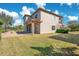 House exterior showcasing a large lawn and stone fire pit at 10389 Henbury St, Orlando, FL 32832