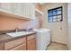 Laundry room with white washer and dryer, and a built-in sink at 10389 Henbury St, Orlando, FL 32832