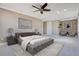 Main bedroom with tufted bed, wood accent wall, and seating area at 10389 Henbury St, Orlando, FL 32832