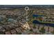 Aerial view of neighborhood with houses, golf course, and lake at 10389 Henbury St, Orlando, FL 32832