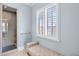 Small bathroom with shower and bench at 10443 Los Feliz Dr, Orlando, FL 32836