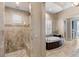 Elegant bathroom with soaking tub, walk-in shower, and tile flooring at 10443 Los Feliz Dr, Orlando, FL 32836