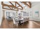 Elegant dining room features hardwood floors, a large wooden table, and high ceilings with exposed beams at 10443 Los Feliz Dr, Orlando, FL 32836