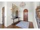 Elegant entryway with hardwood floors, a large mirror, and a statement chandelier at 10443 Los Feliz Dr, Orlando, FL 32836