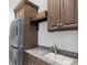 Laundry room with granite countertop, sink, and ample cabinetry at 10443 Los Feliz Dr, Orlando, FL 32836