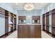 Large walk-in closet with custom built-ins and center island at 10443 Los Feliz Dr, Orlando, FL 32836