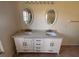 Bathroom with a double vanity and oval mirrors at 10810 Dearden Cir, Orlando, FL 32817