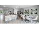 Bright dining area with white chairs and sliding doors to backyard at 1260 Big Bass Dr, Ormond Beach, FL 32174