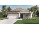 One-story home with gray siding, brown roof, and a two-car garage at 1260 Big Bass Dr, Ormond Beach, FL 32174