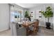 Light-filled dining area with wood table and gray chairs at 1264 Big Bass Dr, Ormond Beach, FL 32174