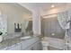 Well-lit bathroom with gray tiling, granite countertop, and modern fixtures at 1331 Foran Manor Rd, Haines City, FL 33844