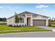 Curb appeal of a one-story house with a gray garage door at 1331 Foran Manor Rd, Haines City, FL 33844