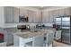 Modern kitchen featuring gray cabinets, granite countertops, and stainless steel appliances at 1331 Foran Manor Rd, Haines City, FL 33844