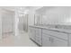 Modern bathroom with double vanity, granite countertop, and glass shower at 1343 Foran Manor Rd, Haines City, FL 33844