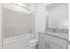 A bathroom featuring a tub with tile surround, a granite vanity, and a neutral color scheme at 1343 Foran Manor Rd, Haines City, FL 33844