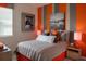 Bedroom with a gray bedspread, orange and gray color scheme and airplane art at 1343 Foran Manor Rd, Haines City, FL 33844