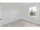 A simple bedroom with a window that provides natural light, carpeted floor, and light-colored walls at 1343 Foran Manor Rd, Haines City, FL 33844