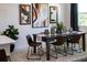 Modern dining room with a dark wood table, seating for six, contemporary art, and a large window at 1343 Foran Manor Rd, Haines City, FL 33844