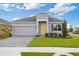 Charming single-story home with a yellow front door, manicured lawn and gray brick driveway at 1343 Foran Manor Rd, Haines City, FL 33844