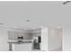 Bright kitchen with gray cabinets, granite countertops, and stainless steel appliances at 1343 Foran Manor Rd, Haines City, FL 33844