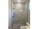 Modern bathroom with marble tile shower, rainfall shower head, pebble flooring and toilet at 1360 Jayce Ct, Geneva, FL 32732