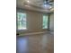 Spacious bedroom with tray ceiling, fan, recessed lighting, tile floors and multiple windows at 1360 Jayce Ct, Geneva, FL 32732