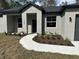 Charming single-Gathering home with a manicured lawn, landscaped garden, and a sidewalk leading to the front door at 1360 Jayce Ct, Geneva, FL 32732