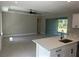 Open living room with sliding glass doors to the patio, recessed lighting and gray tile flooring at 1360 Jayce Ct, Geneva, FL 32732