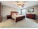 King bedroom with ceiling fan, dresser, and large window at 13651 Eridanus Dr, Orlando, FL 32828