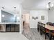 Bright dining room with wood flooring and a view into the kitchen at 13651 Eridanus Dr, Orlando, FL 32828