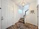 Bright entryway with hardwood floors, staircase, and a white door at 13651 Eridanus Dr, Orlando, FL 32828