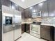 Modern kitchen with stainless steel appliances and dark cabinetry at 13651 Eridanus Dr, Orlando, FL 32828