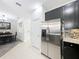 Stainless steel refrigerator in a modern kitchen with dark cabinetry at 13651 Eridanus Dr, Orlando, FL 32828