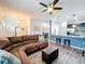 Open living room and kitchen with hardwood floors, a sectional sofa, and a ceiling fan at 13651 Eridanus Dr, Orlando, FL 32828