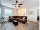 Living room with sectional sofa, hardwood floors, and a ceiling fan at 13651 Eridanus Dr, Orlando, FL 32828