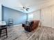 Living room with brown sectional sofa, hardwood floors, and a ceiling fan at 13651 Eridanus Dr, Orlando, FL 32828