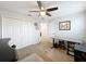 Home office with standing desk, shelving, and ceiling fan at 13651 Eridanus Dr, Orlando, FL 32828