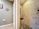 Walk-in shower with pebble floor and built-in seat at 13651 Eridanus Dr, Orlando, FL 32828